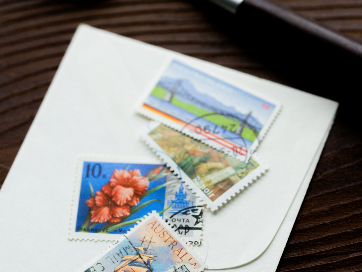 A professional outreach director in Atlanta reviewing a non-profit postage audit and replacing a rented meter with rolls of bulk forever stamps.